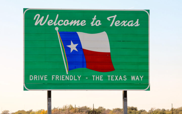 Texas road sign upon entering the state that says "Welcome to Texas" and "Drive Friendly - The Texas Way"