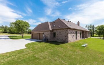 photo of a driveway leading up to a home for sale