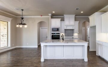 photo of a kitchen showing oven, stove, sink, and countertop