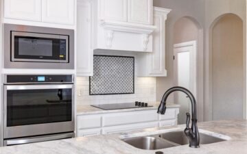 photo of a kitchen showing oven, stove, and sink